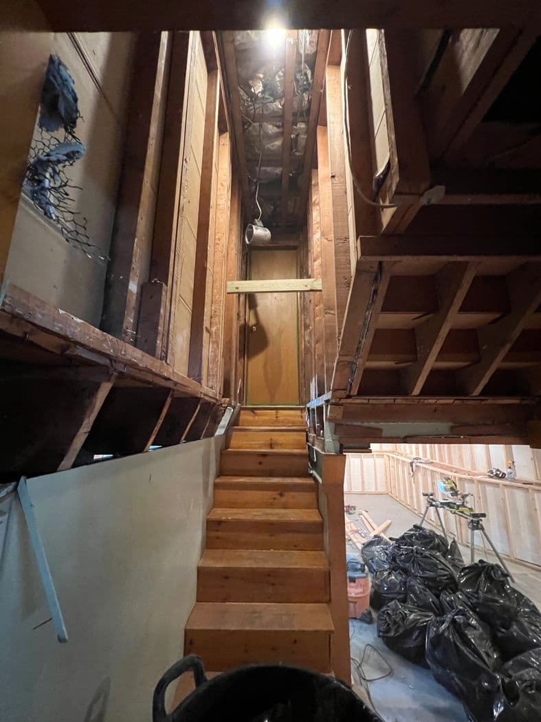 New wood stair and wall framing during a full basement renovation